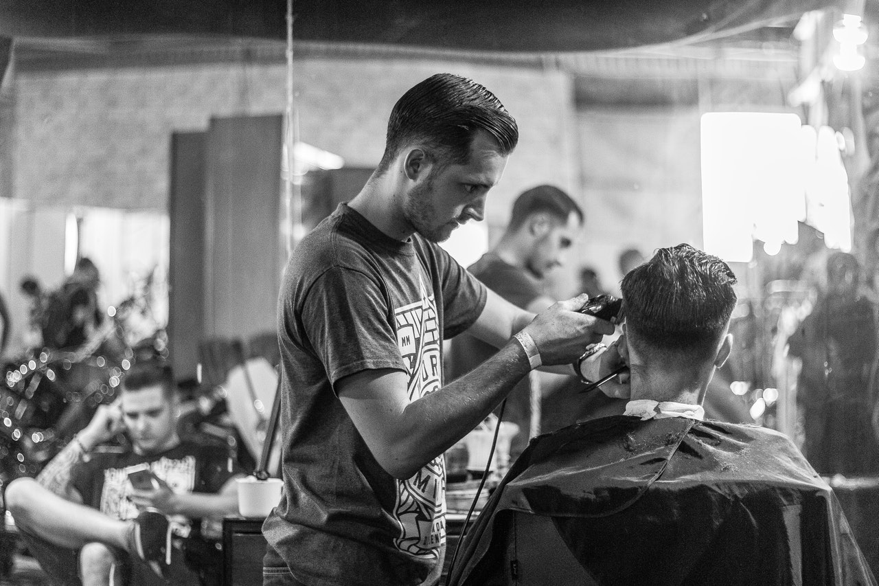 a person trimming a man's hair/ how to fix a short haircut